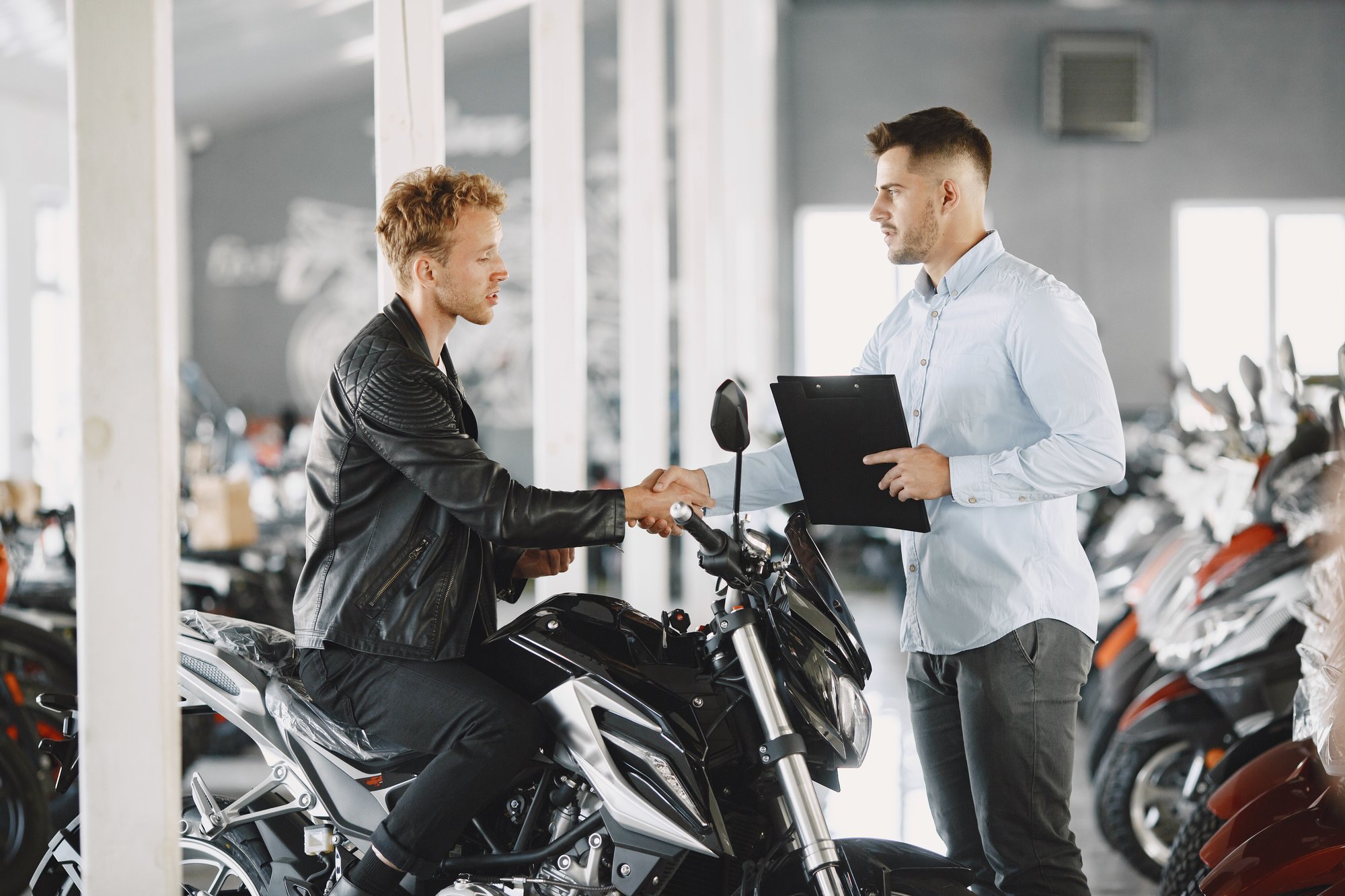 man-choosed-motorcycles-moto-shop-guy-black-jacket-manager-with-client